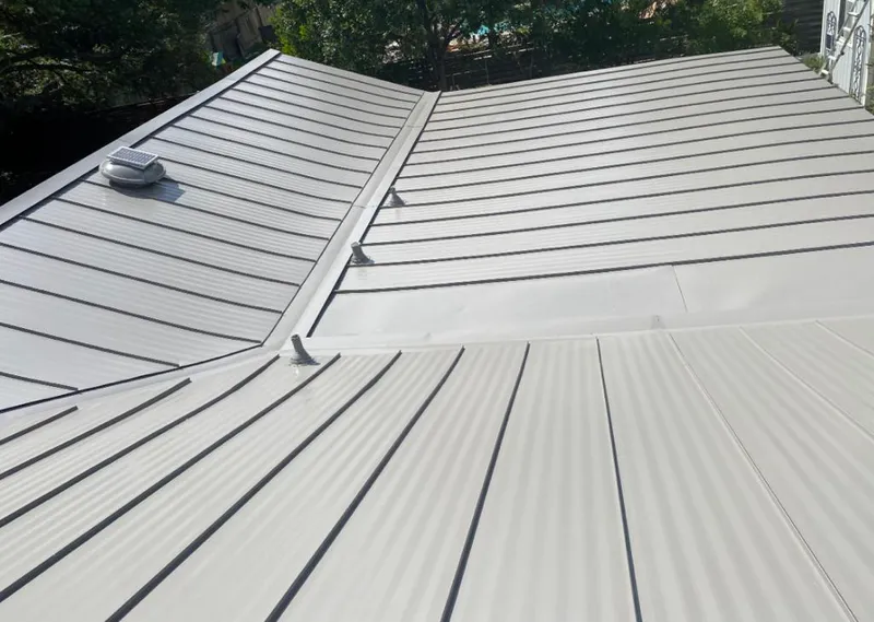 Solar attic fan installed on a metal roof for Roof Ventilation in Germantown